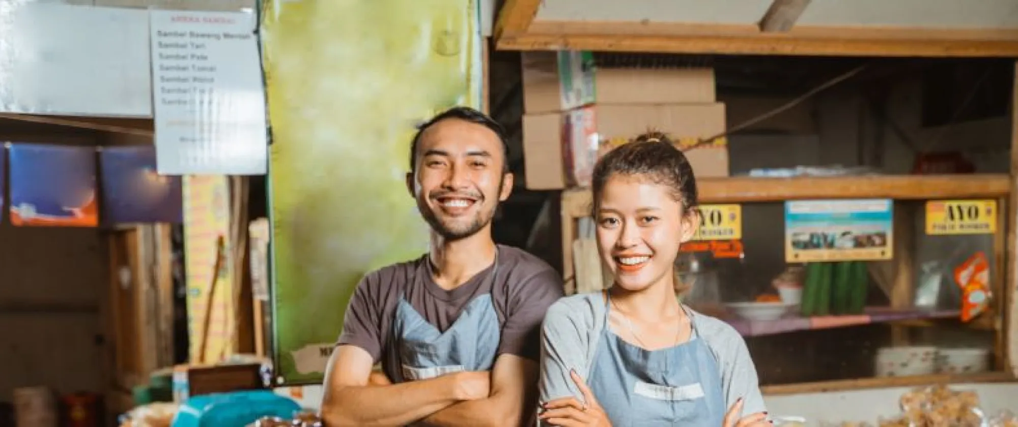 hero-image-smiling-asian-man-woman-wearing-apron-standing-traditional-stall