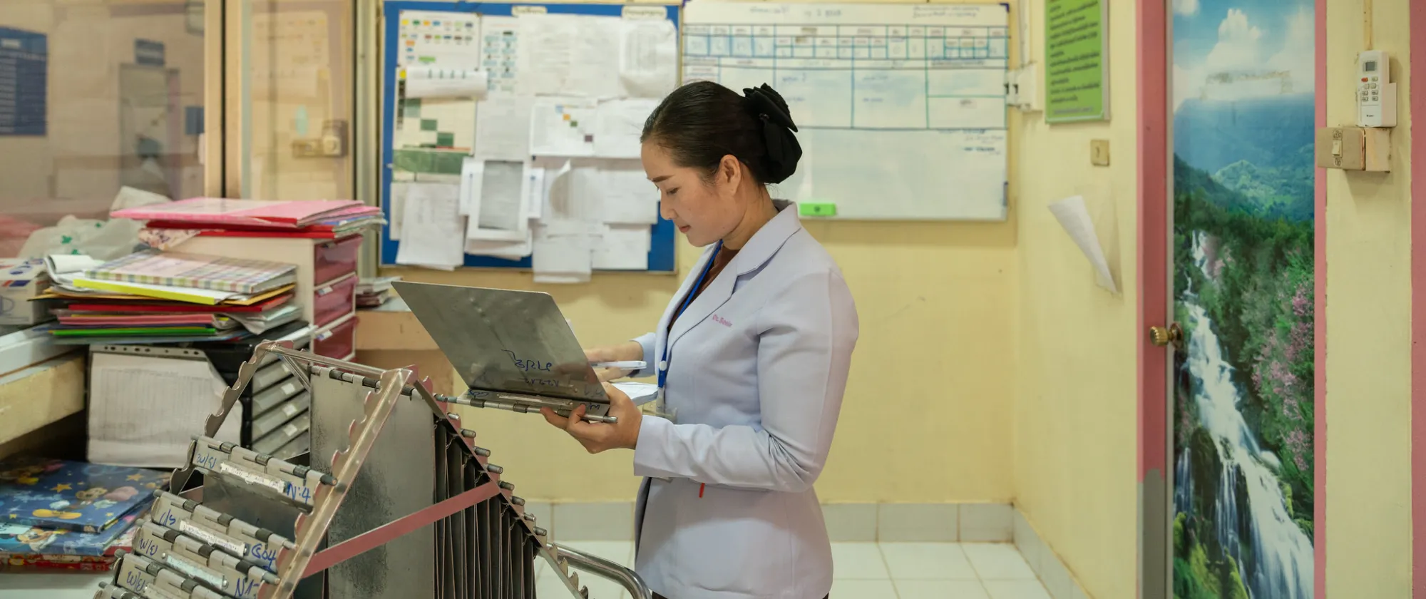 Nurse looks at a medical chart.