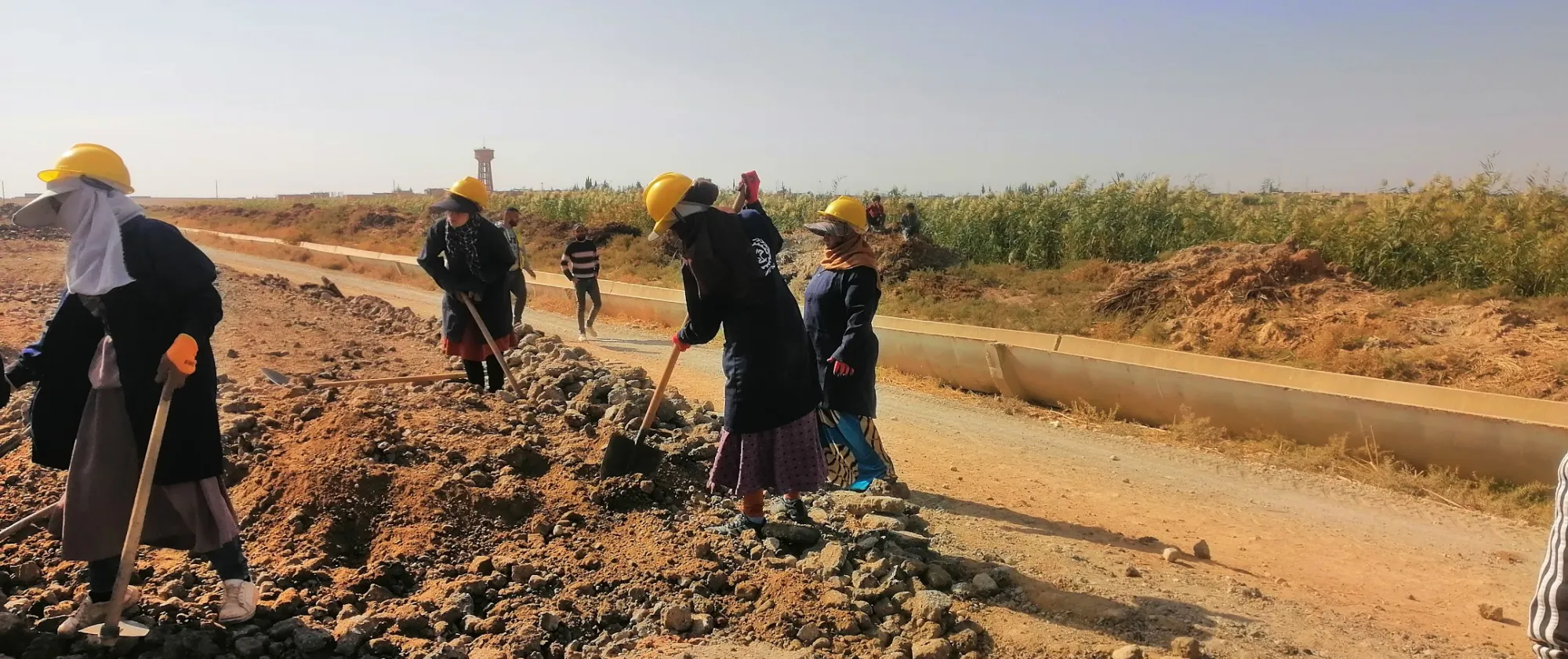 Women workers rehabilitating roads outside of Aleppo, Syria