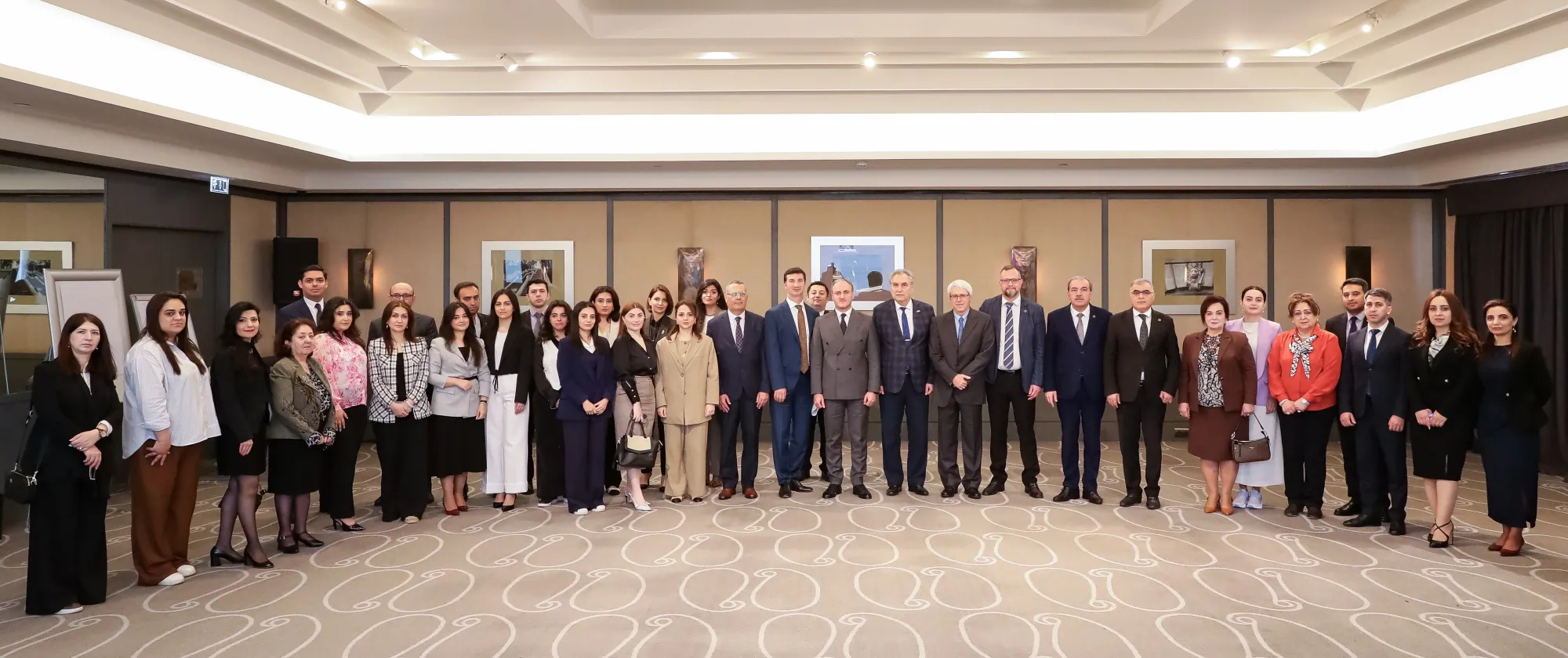 A row of people standing for the group photo