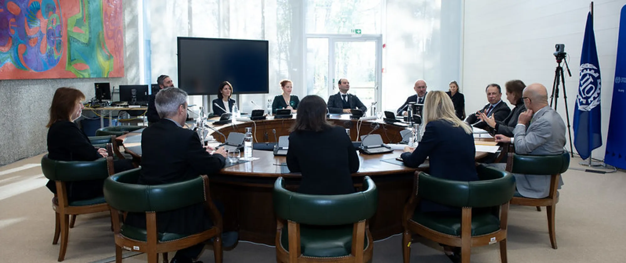 high level managers from ILO and Eni at a round table in the ILO premises