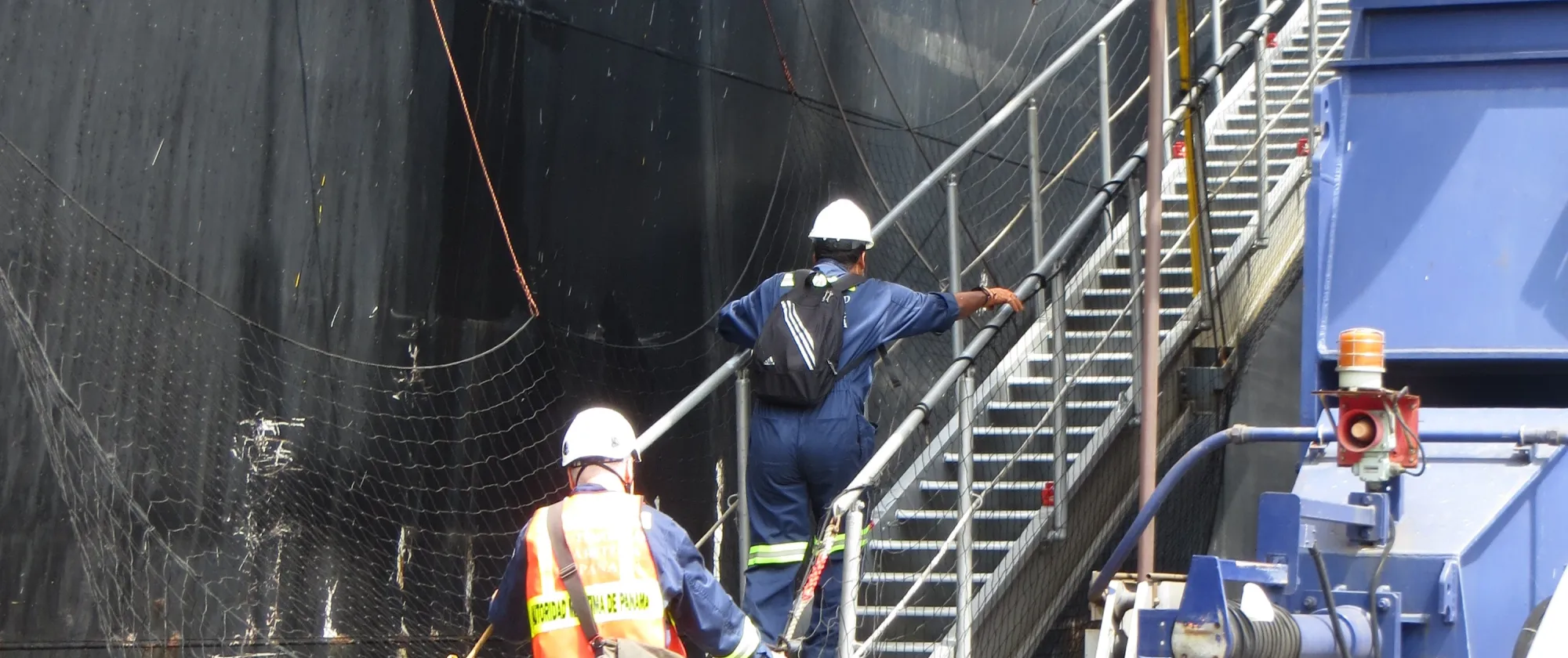 Two labour inspectors are boarding a container ship