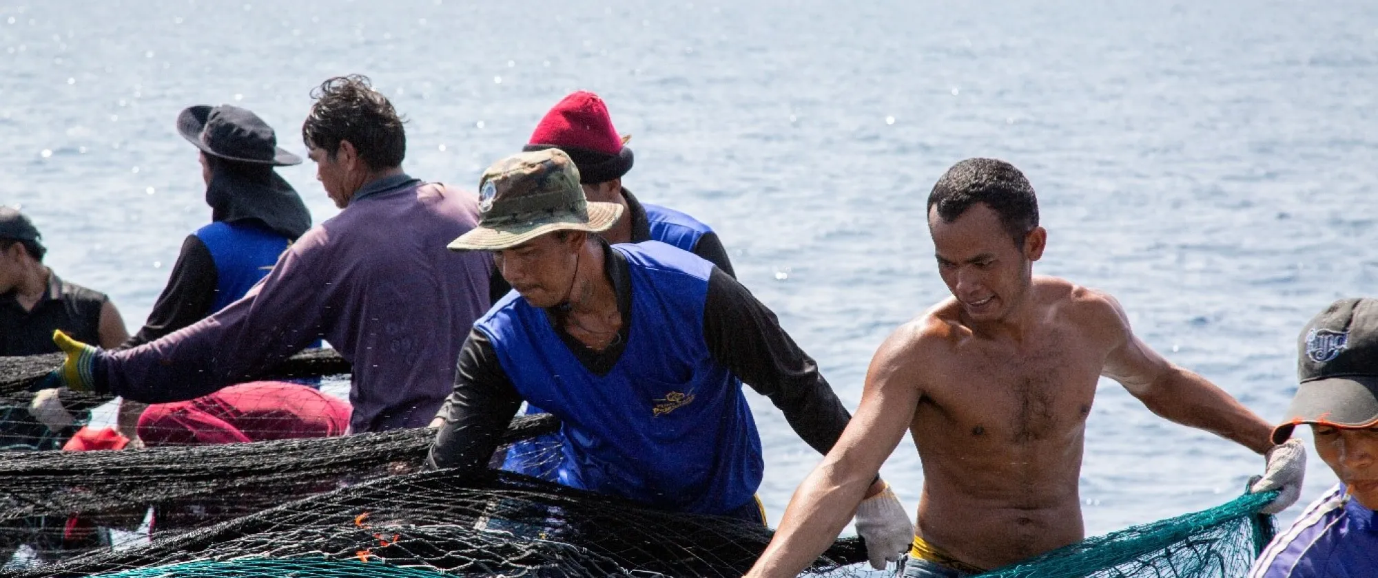 Cambodian migrant fishers set a trawl on a fishing vessel in Rayong, Thailand.