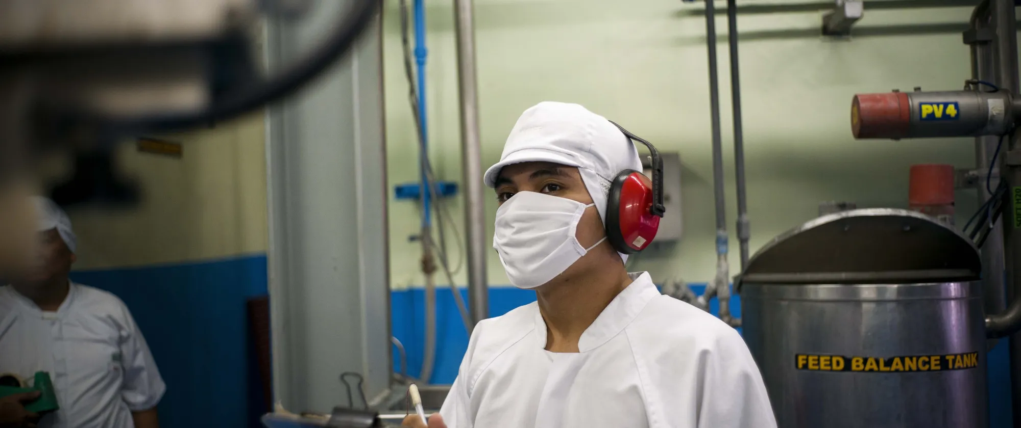 Man in full PPE gear using a checklist