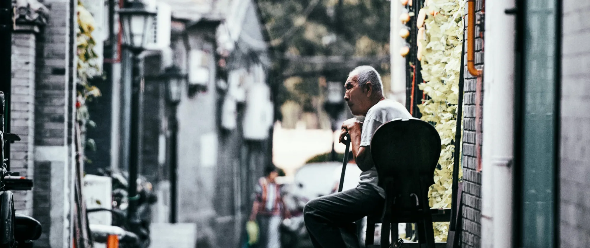 Elderly asian man sitting on a chair