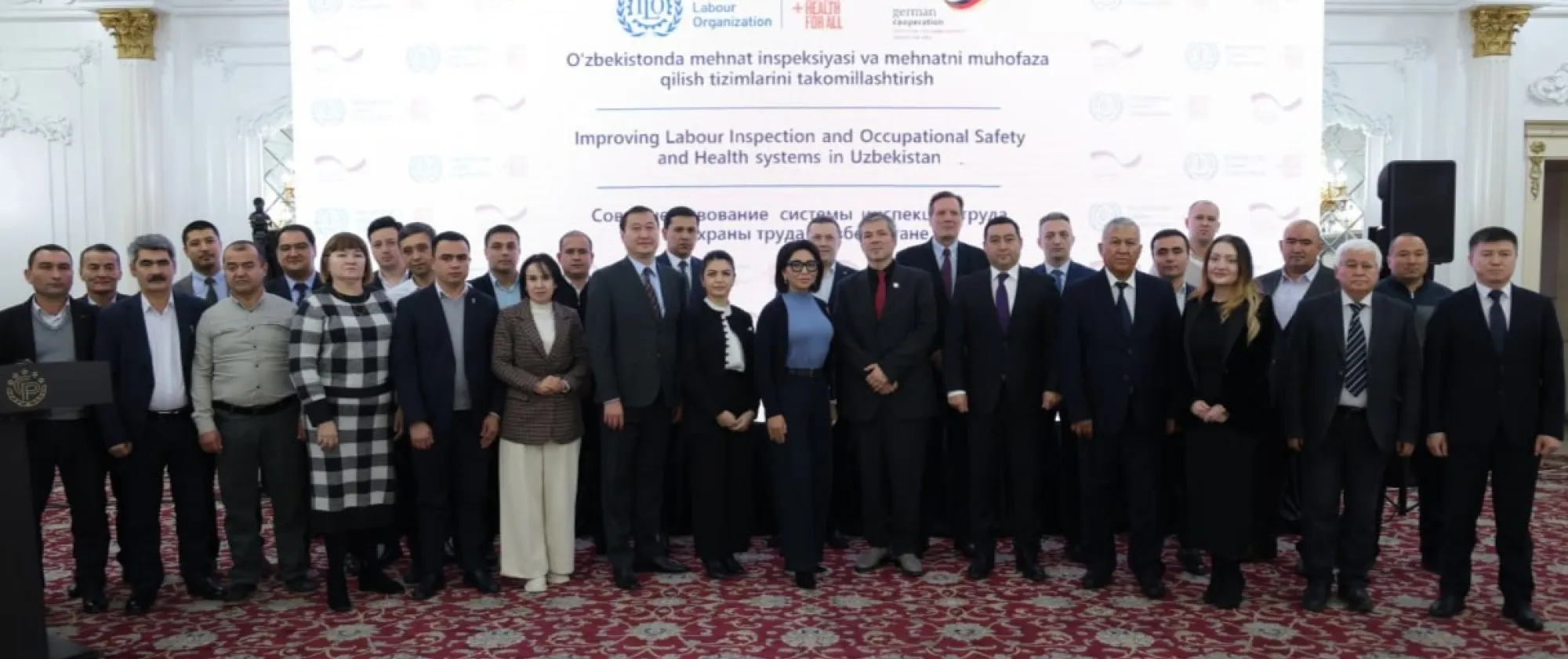 Group of people standing in front of a banner