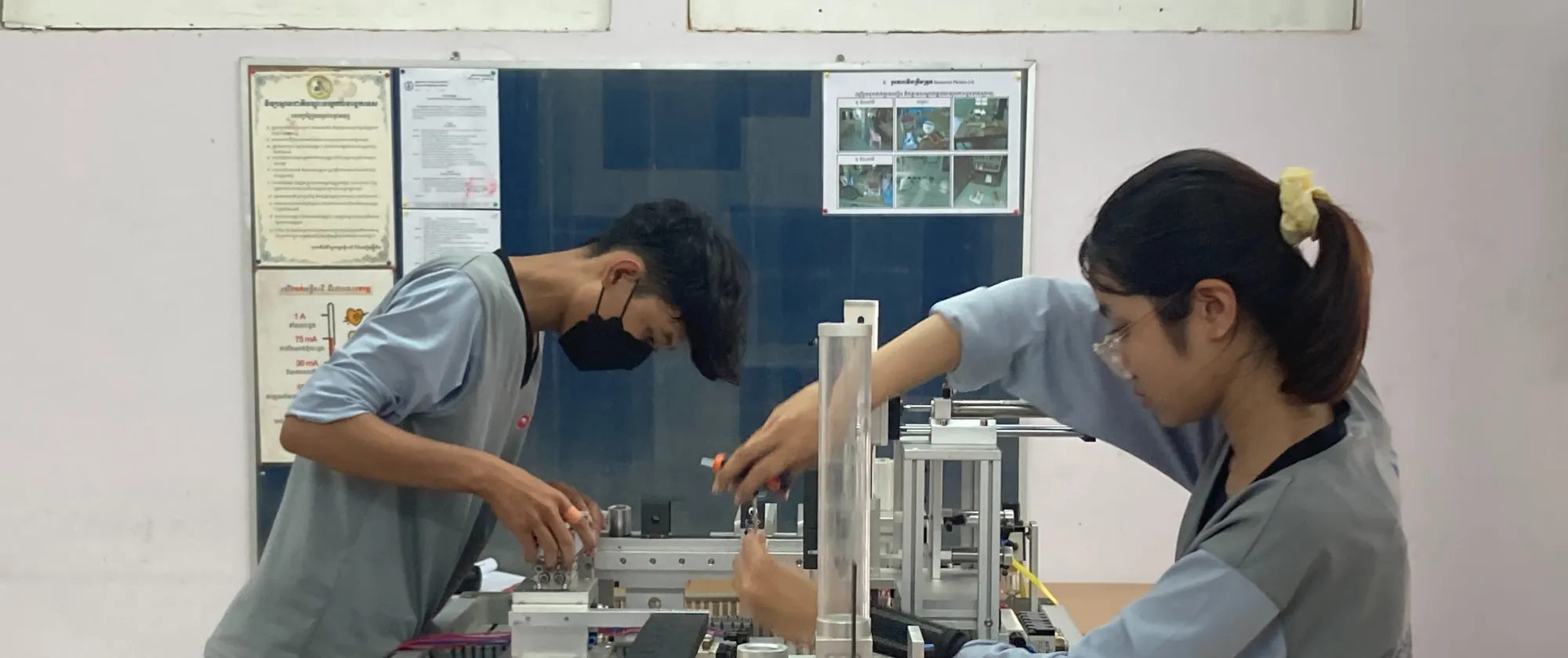Woman and man use electronics equipment. 