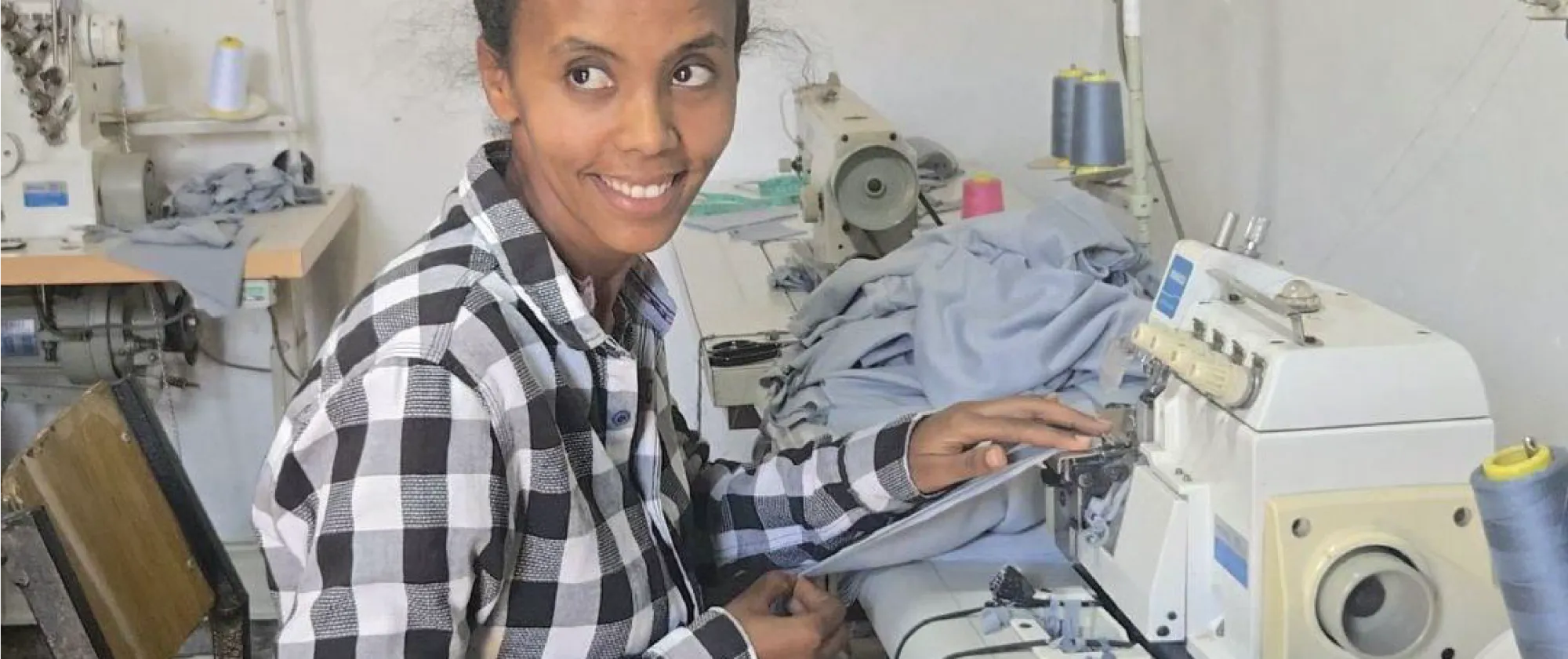 Woman tailor working at a sewing machine