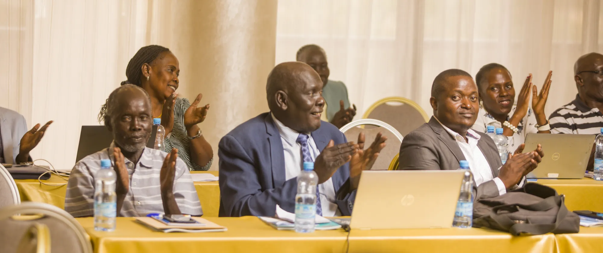 Participants clapping during a meeting
