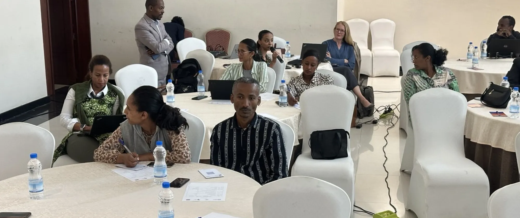 Plenary session where participants discussing