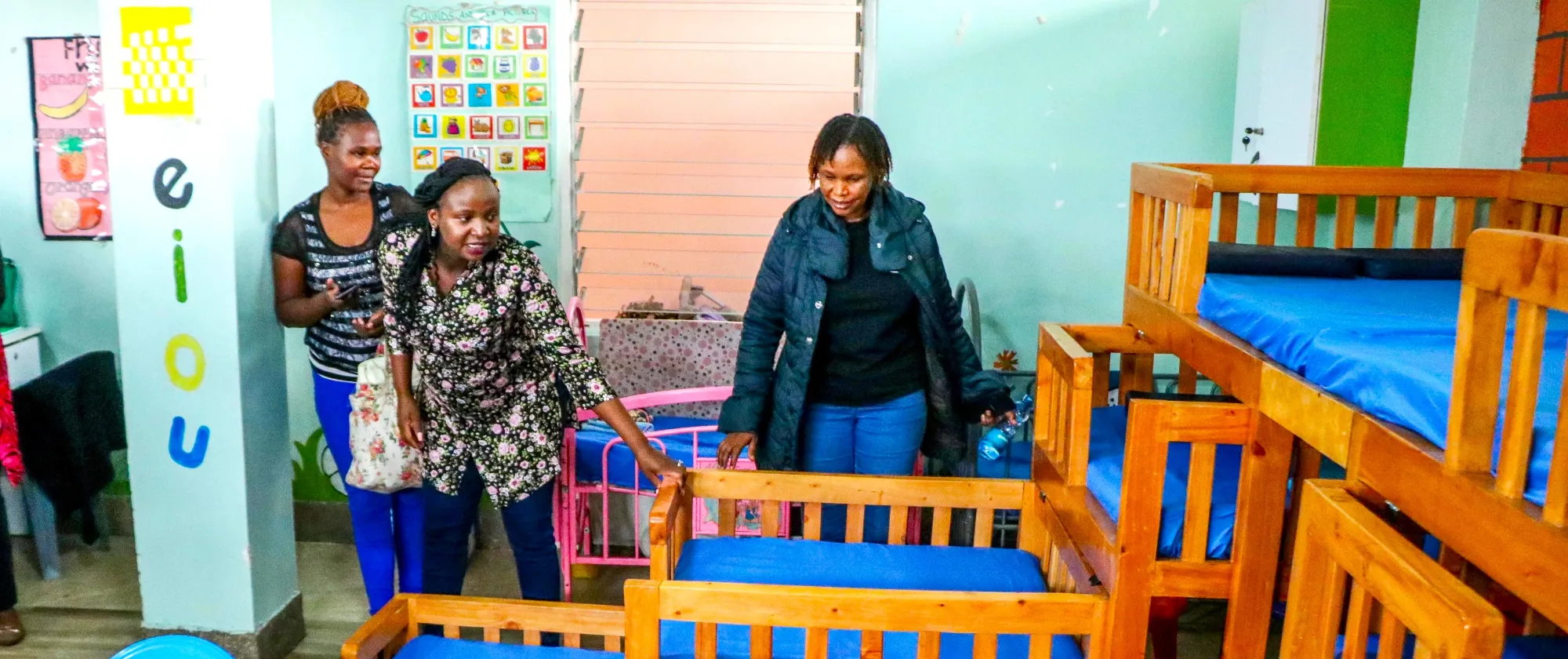 Wow Mom founder Peninnah showing her guests the day care facility at Mwariro Market 