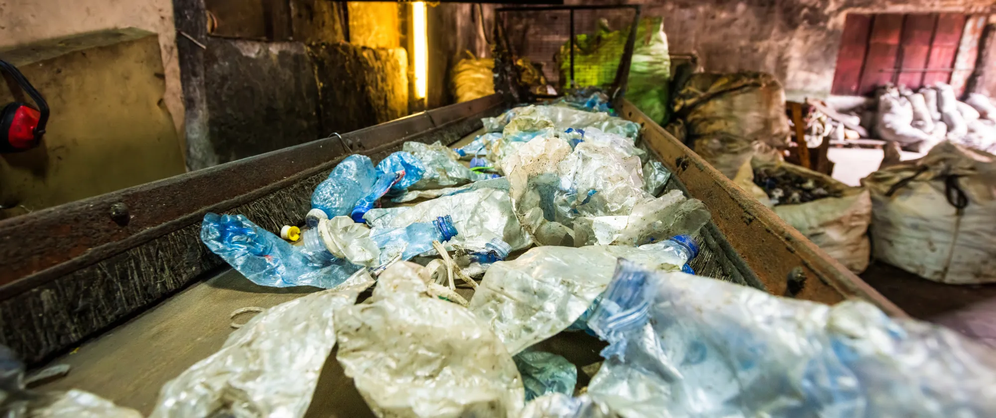  Plastic garbage on a conveyor belt at waste recycling factory