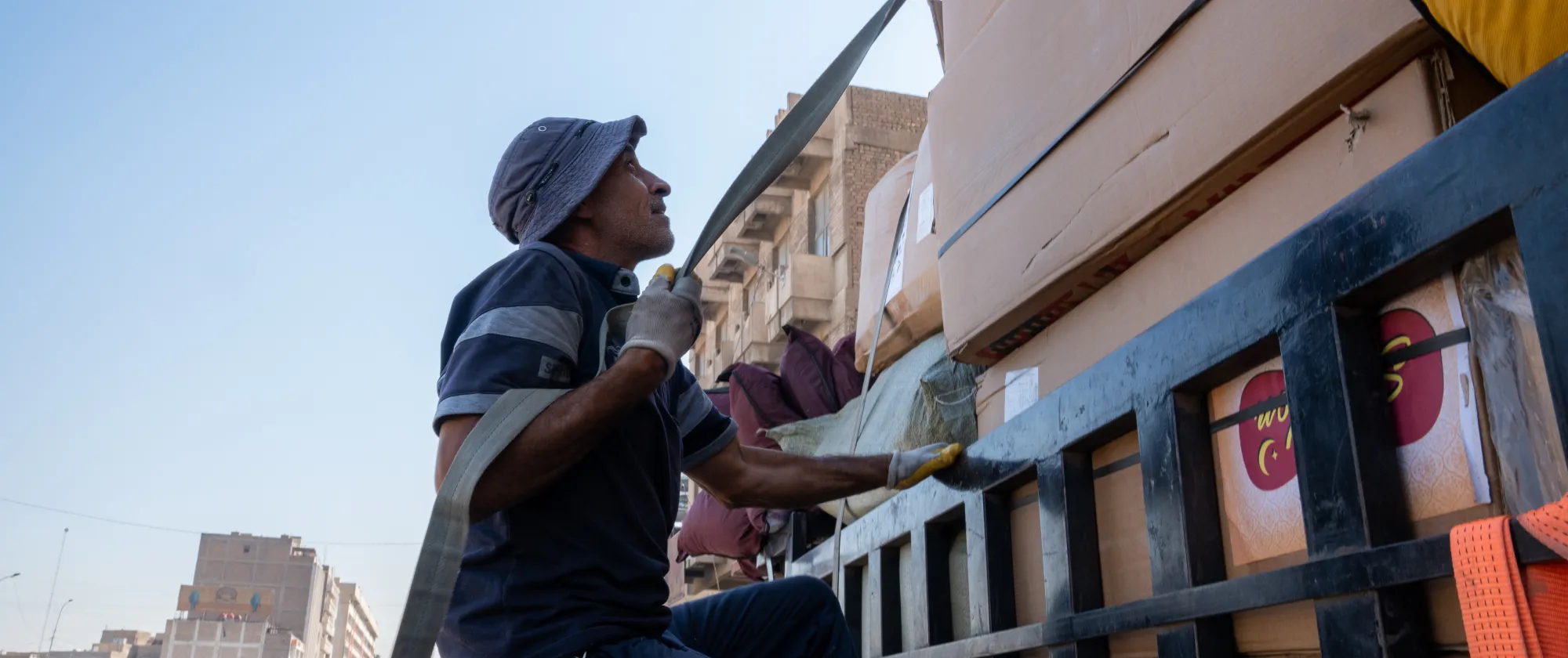 Jabar, an ILO beneficiary, unloads a delivery of goods at Shorja Market in Baghdad. 12 November 2024.