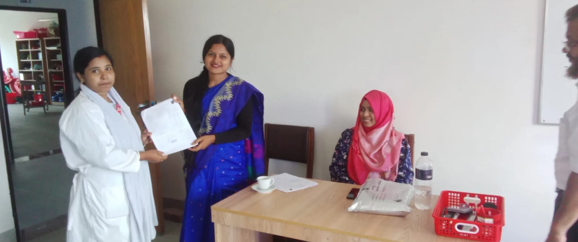 Bijly Baroi giving certificate to a trainee she trained in caregiving