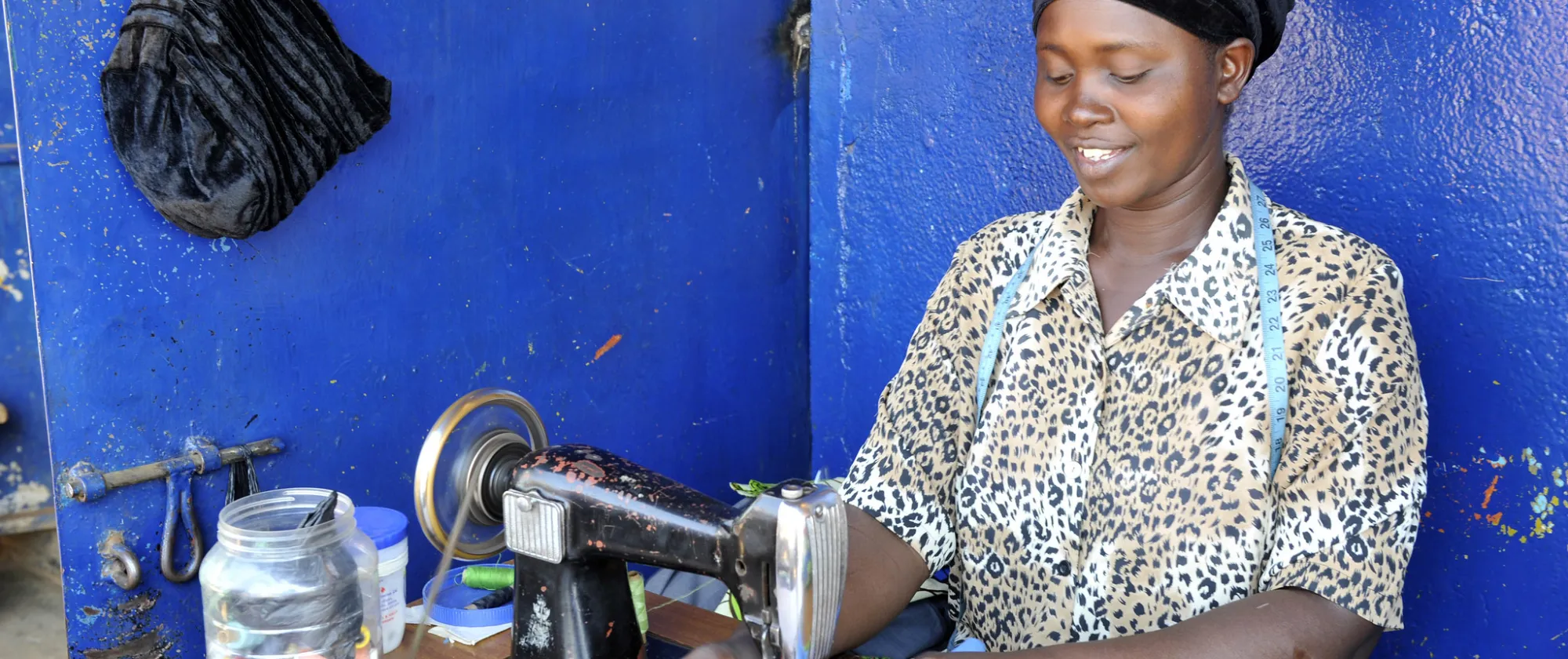Female Entrepreneur in Kenya working on a sewing machine.