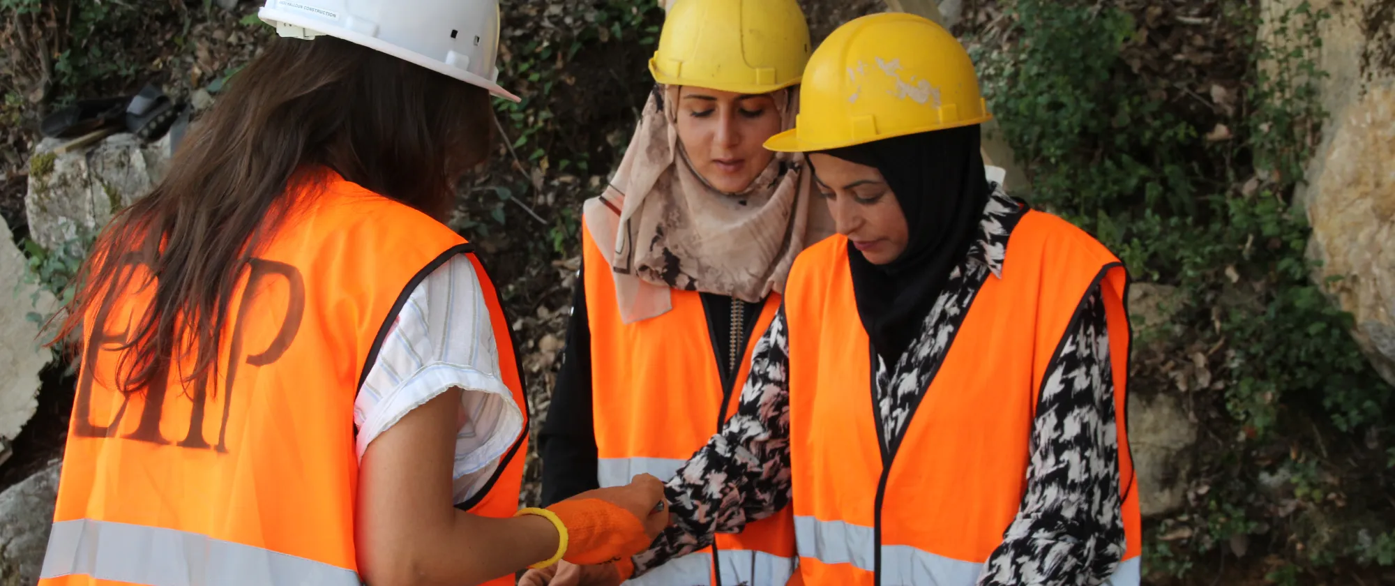    Workers engaged in building the reservoir demonstrate building techniques. 