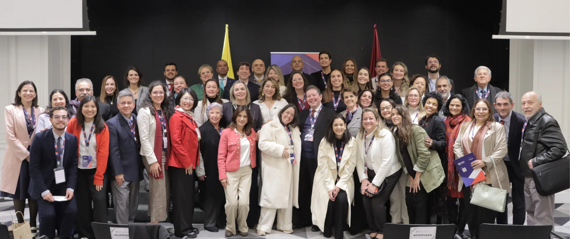 Group photo from the Colombia–Brazil Exchange Meeting; over 50 participants are smiling as they pose together.