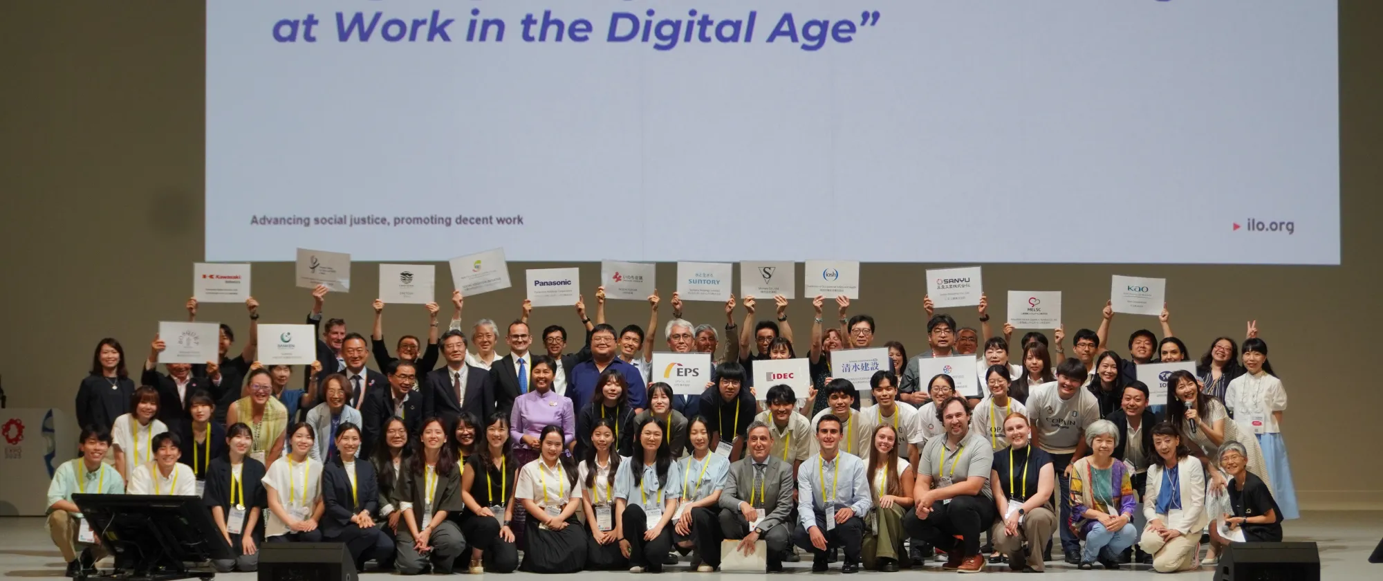 Representatives from various enterprises and professional organizations proudly display their support for the students’ at the Youth Congress in Osaka, Japan.