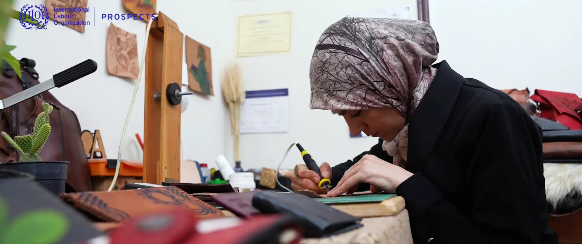 Ezdihar working on a leather product