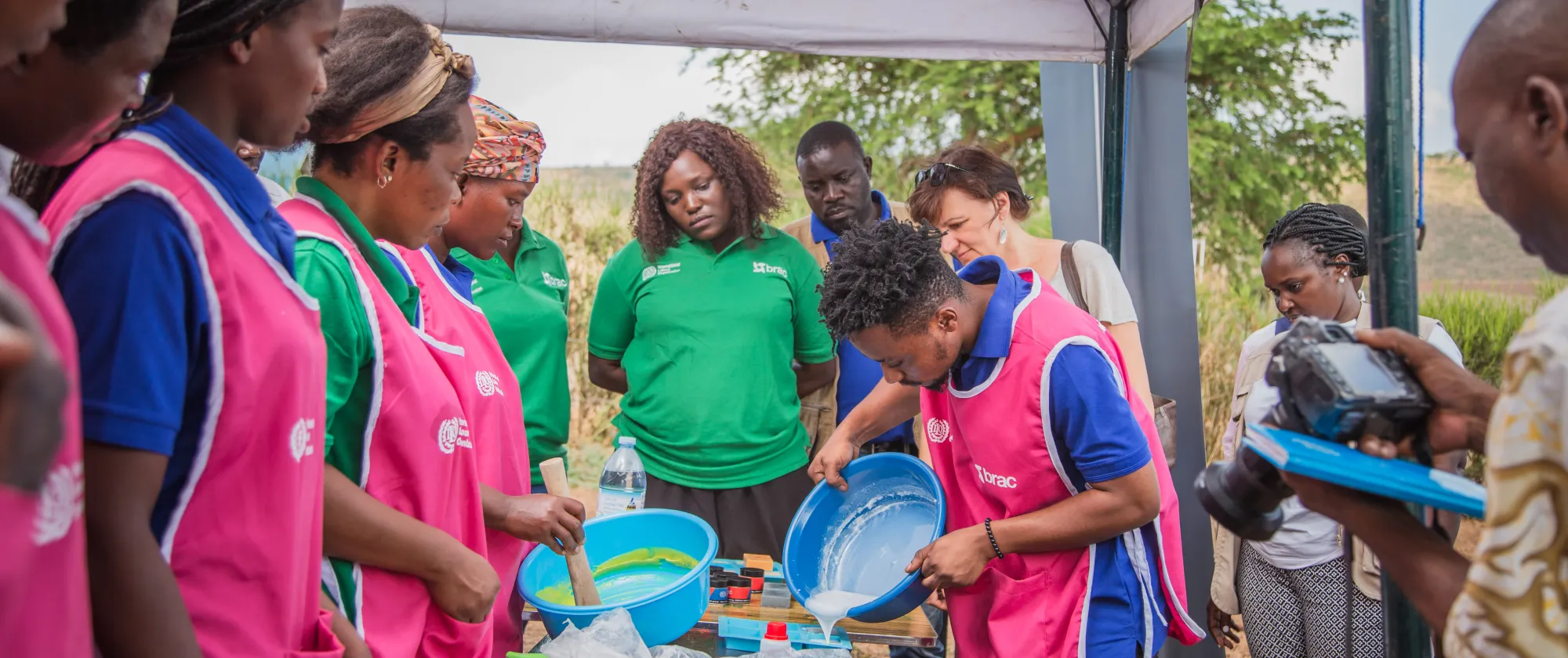 young people showing their products during donor visit in Uganda