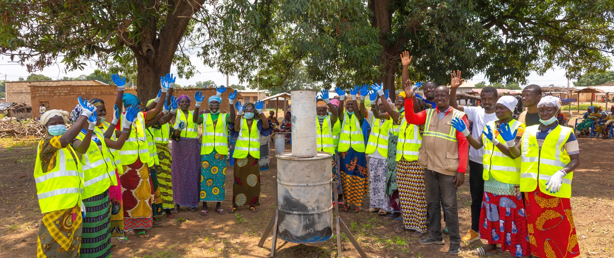 Women in Kapekaha village in northern Côte d'Ivoire stand proudly in a line, waving their hands after the completion of an ILO training course