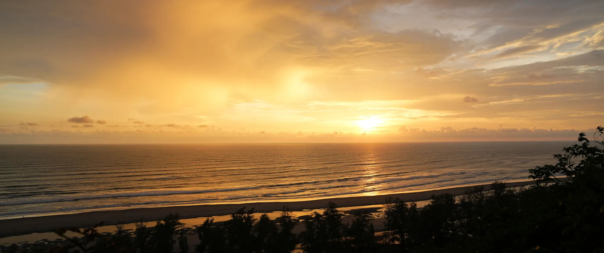 Sunset over the Bay of Bengal, viewed from a hilltop in Himchari, one of the area’s favorite spots where visitors gather to watch the day fade into vibrant colors