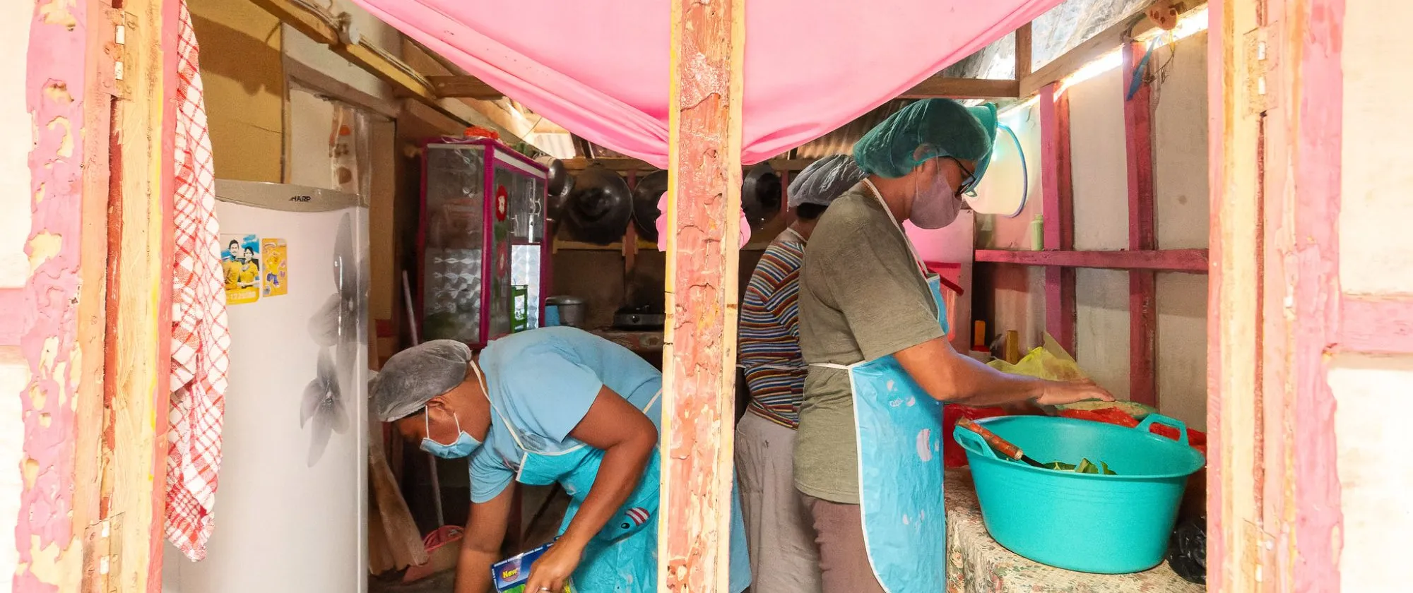 three SME workers in a small kitchen 