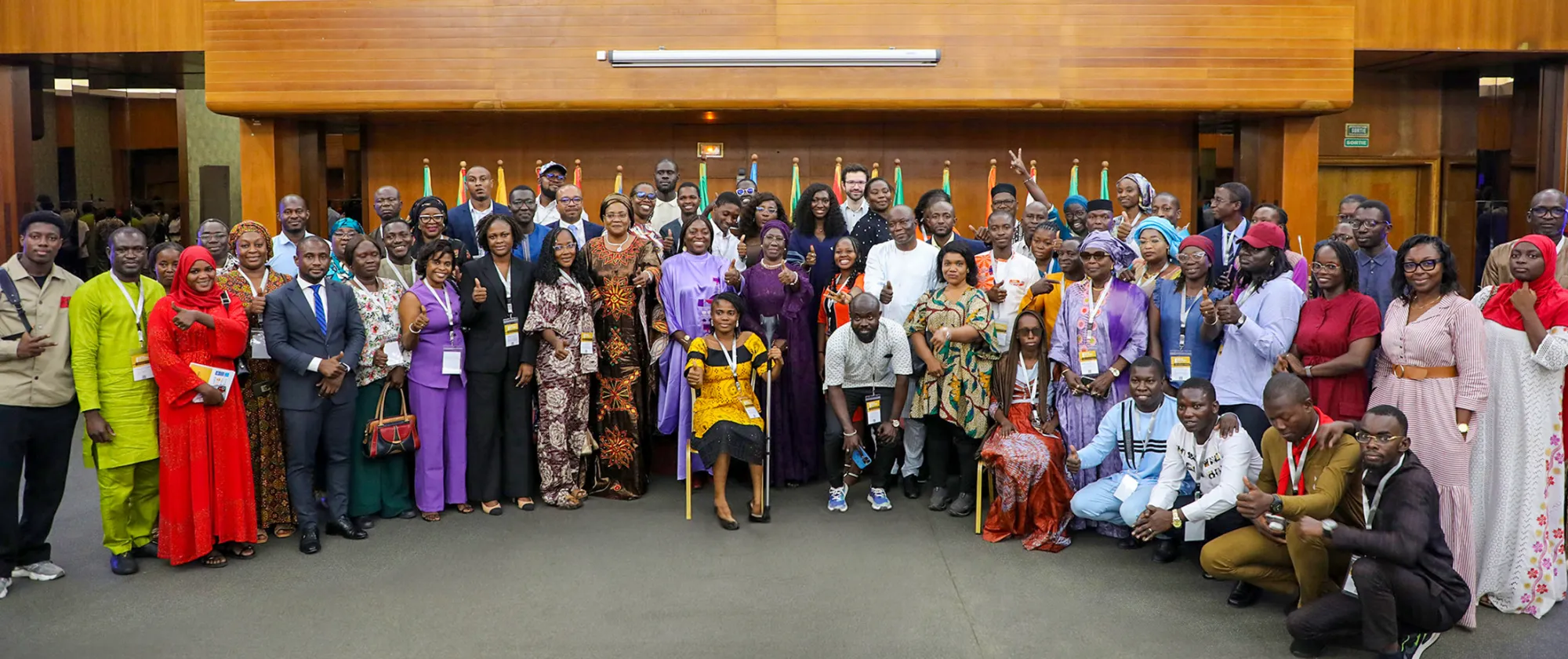 Group photo of around 70 participants at the closing of the 4th Annual West Africa and Sahel Youth Forum in Dakar, featuring young women and men, government officials, and partners standing and smiling together.