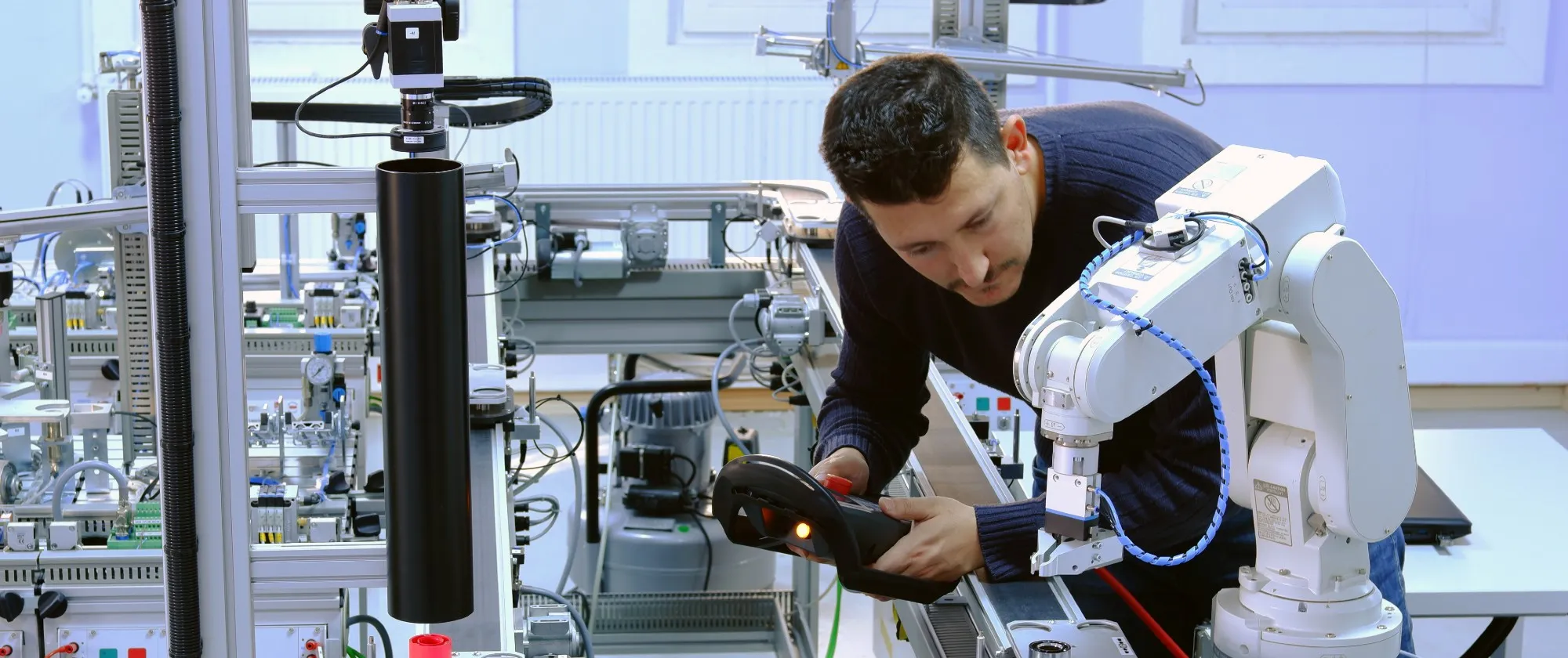 Man with a robot in a workplace