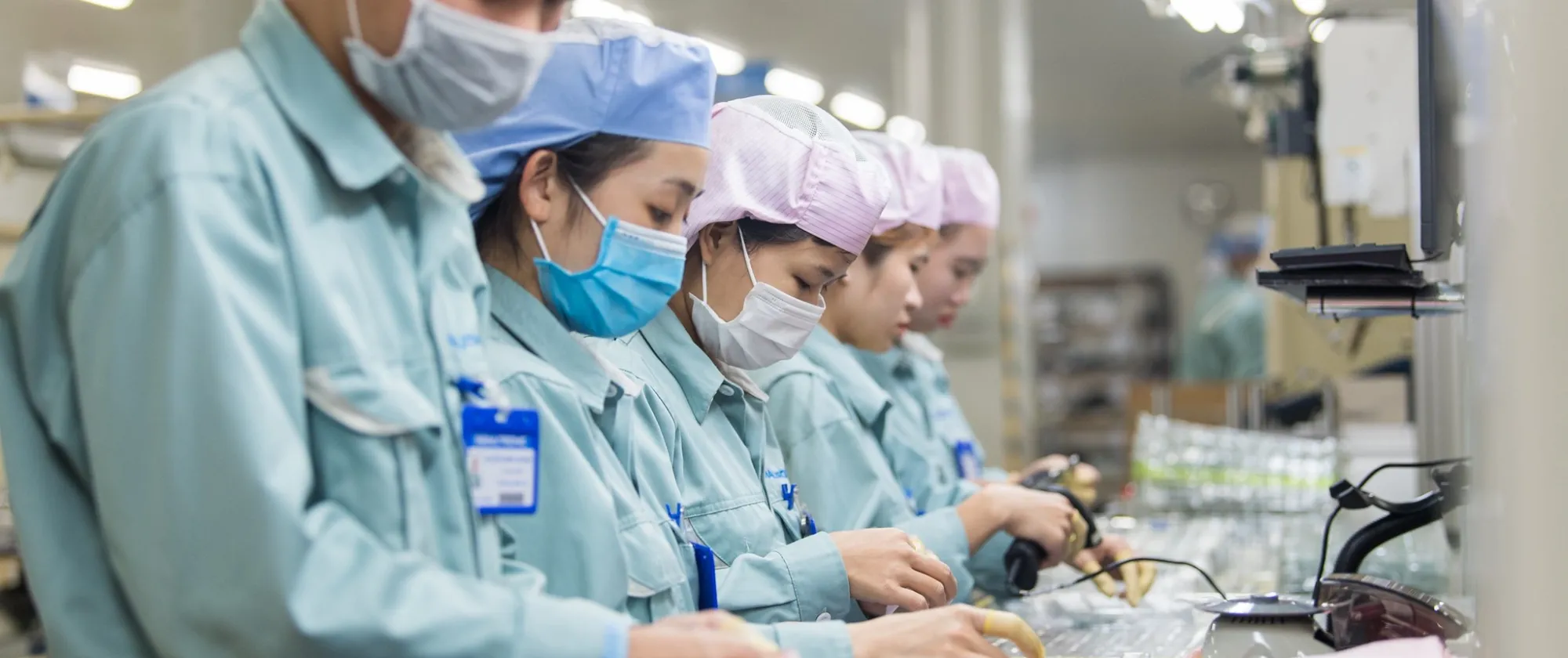 Workers check electronic components at a factory in Viet Nam. 