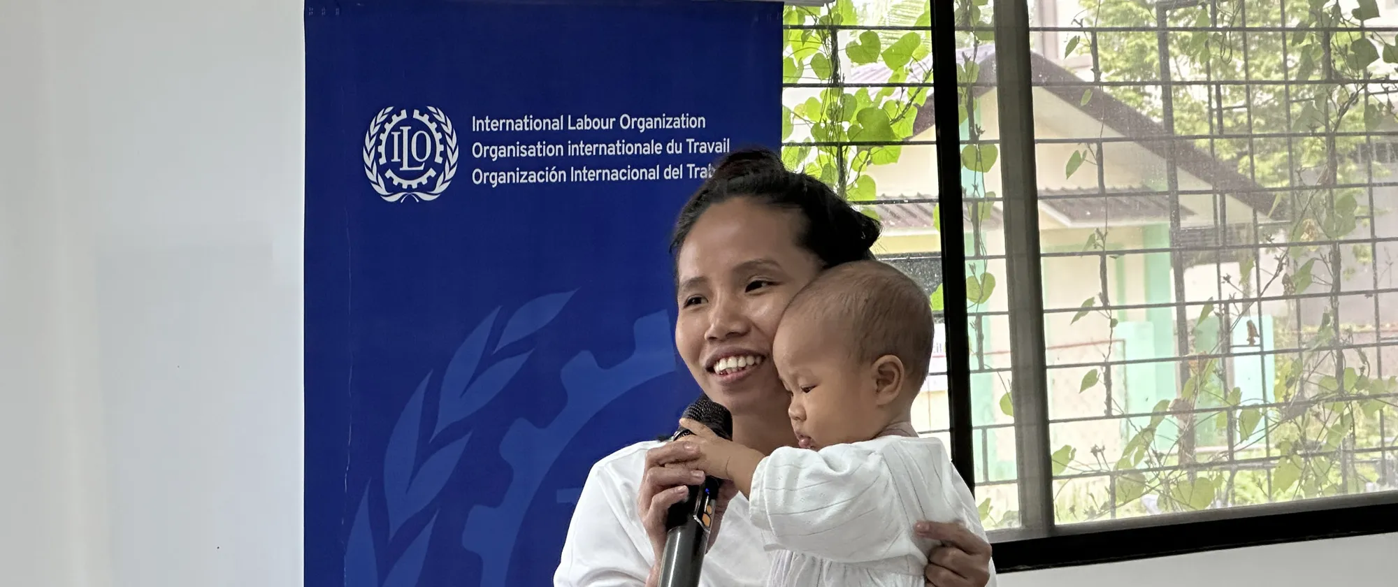 a woman speaking in a training with her baby