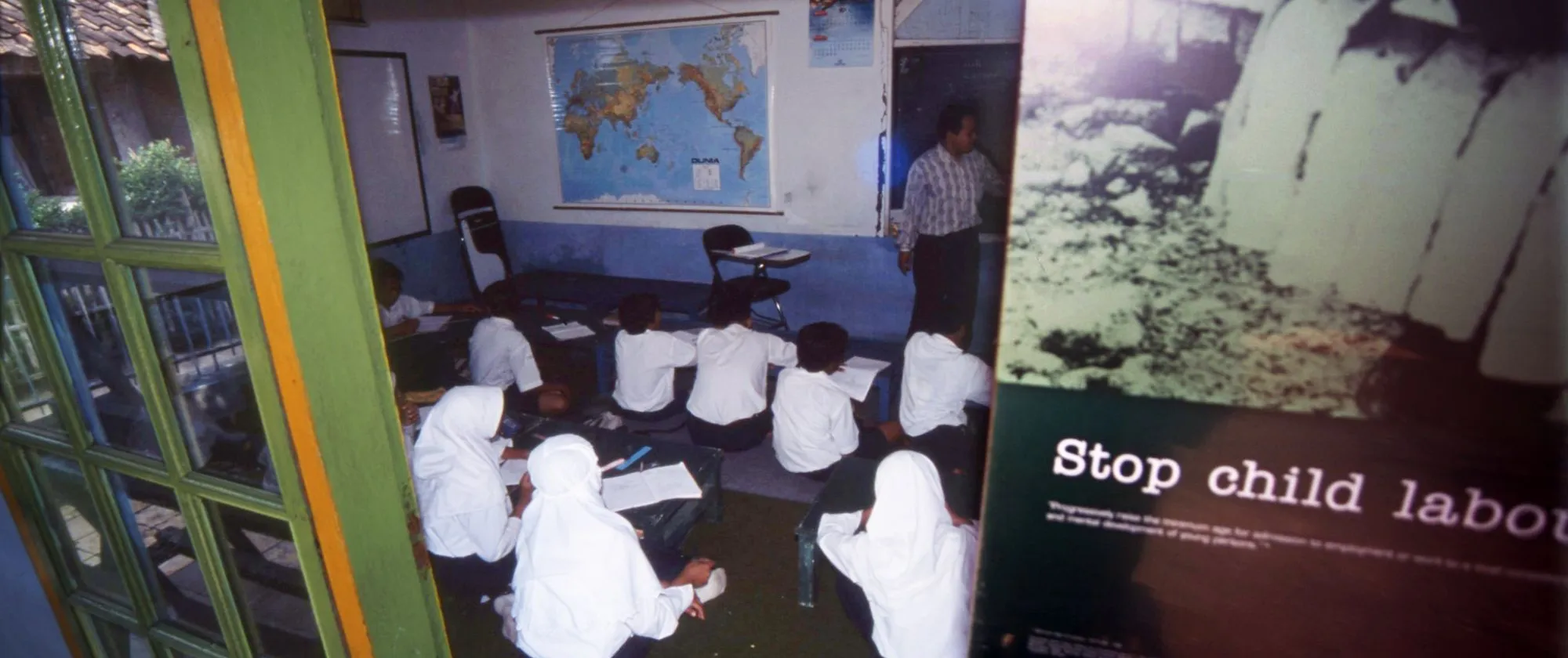 several students sitting inside a small class room
