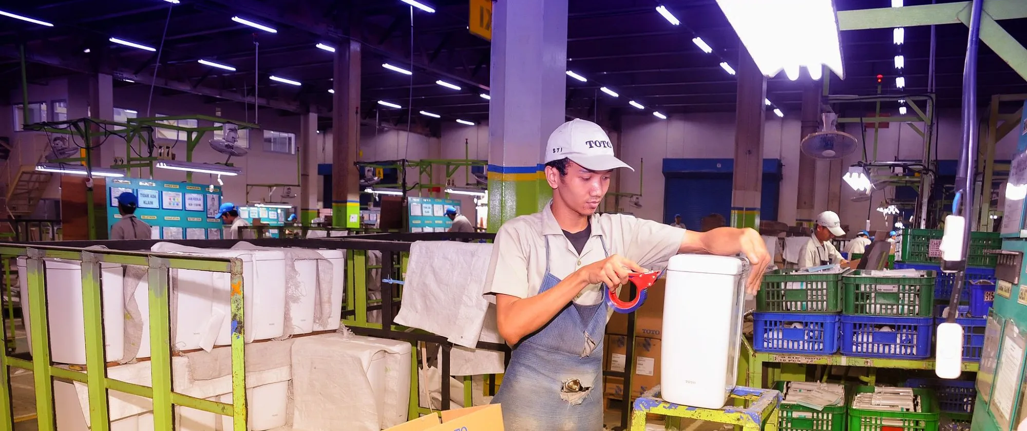 a young male worker at a big factory 