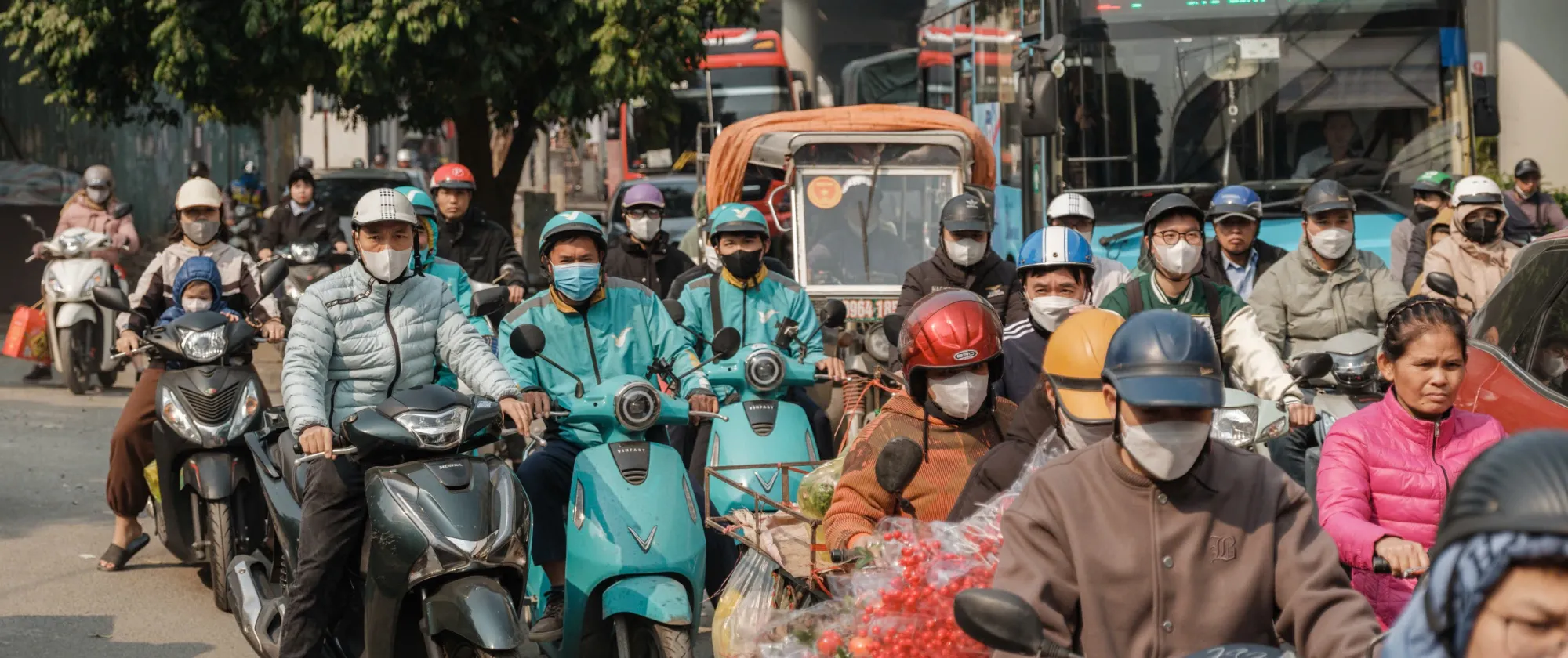 Chaotic traffic of motorbikes and cars travelling to work in Viet Nam