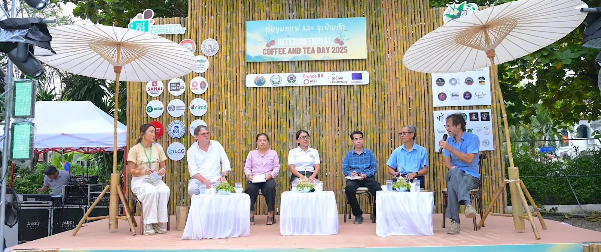 Speakers engaged in conversation on stage.