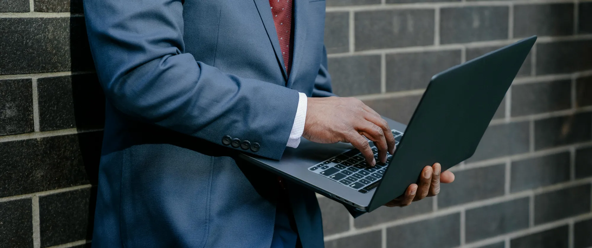 man typing on laptop