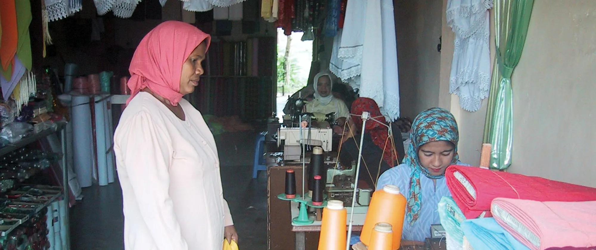 three women in a sewing course