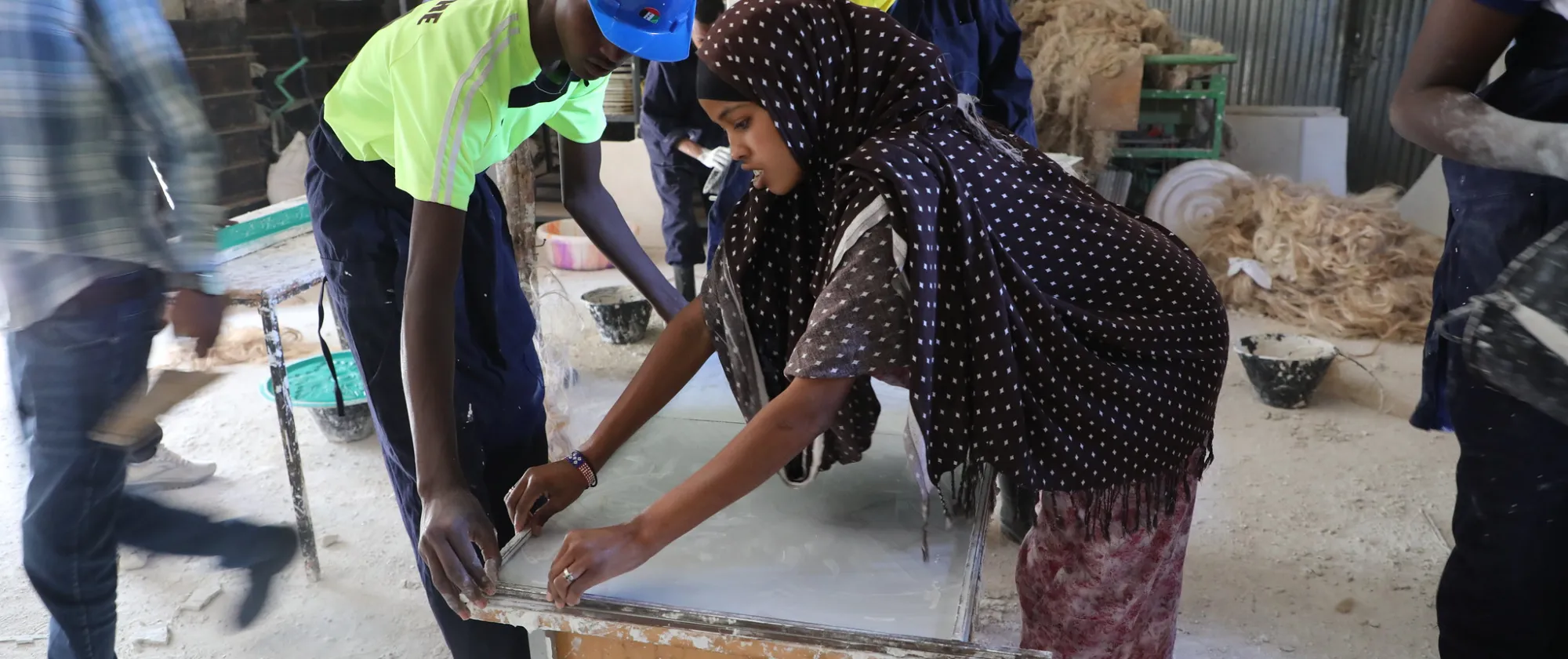 a young woman and a man attending training on woodwork in Ethiopia.