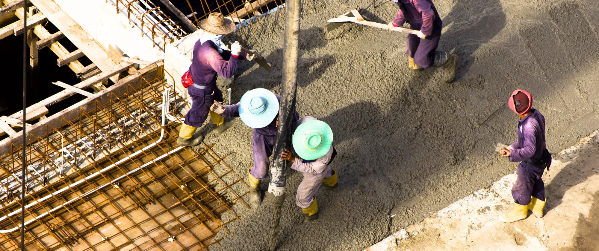 Workers pouring cement as a foundation for a new buildings, Brunei