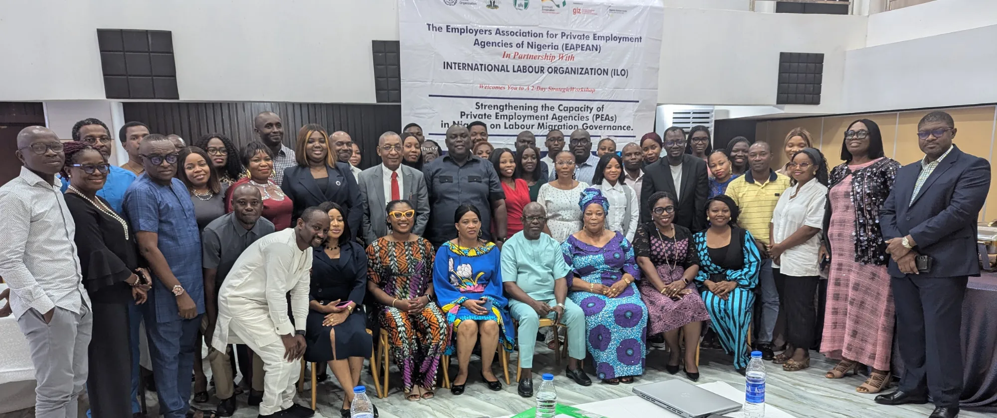 Participants take a group photo at a workshop on fair recruitment and protect the rights of Nigerian workers