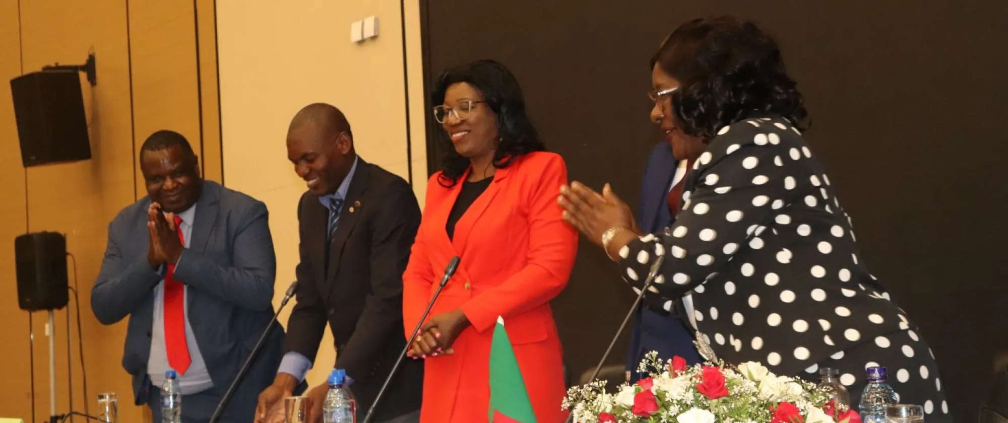Minister of Labour and Social Security, Minister Mrs. Brenda Tambatamba shares a light moment with the high-table after delivering her remarks at the TCLC meeting in Lusaka.