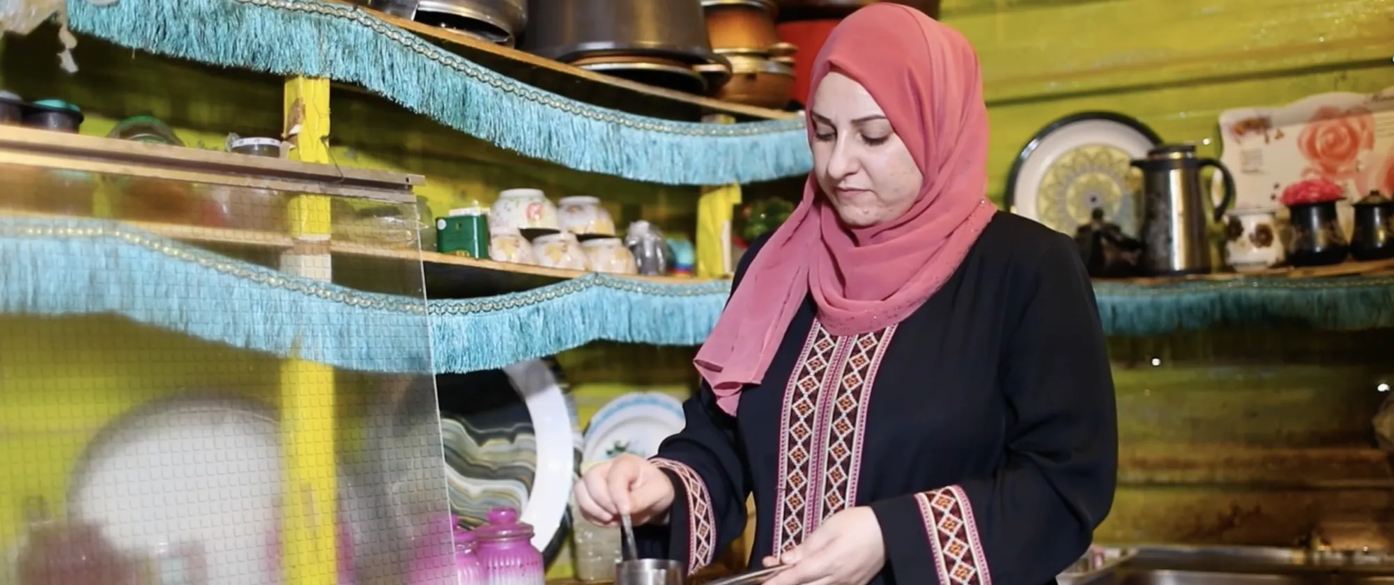 Tailor Hanan Khaled Al-Khawalda prepares coffee for her guests in the kitchen of her home in Jordan’s Za’atari camp for Syrian refugees on October 28, 2025. 