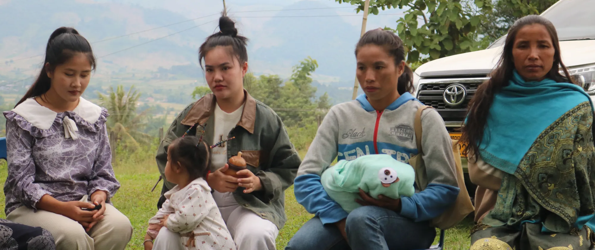 Women and babies sit together 
