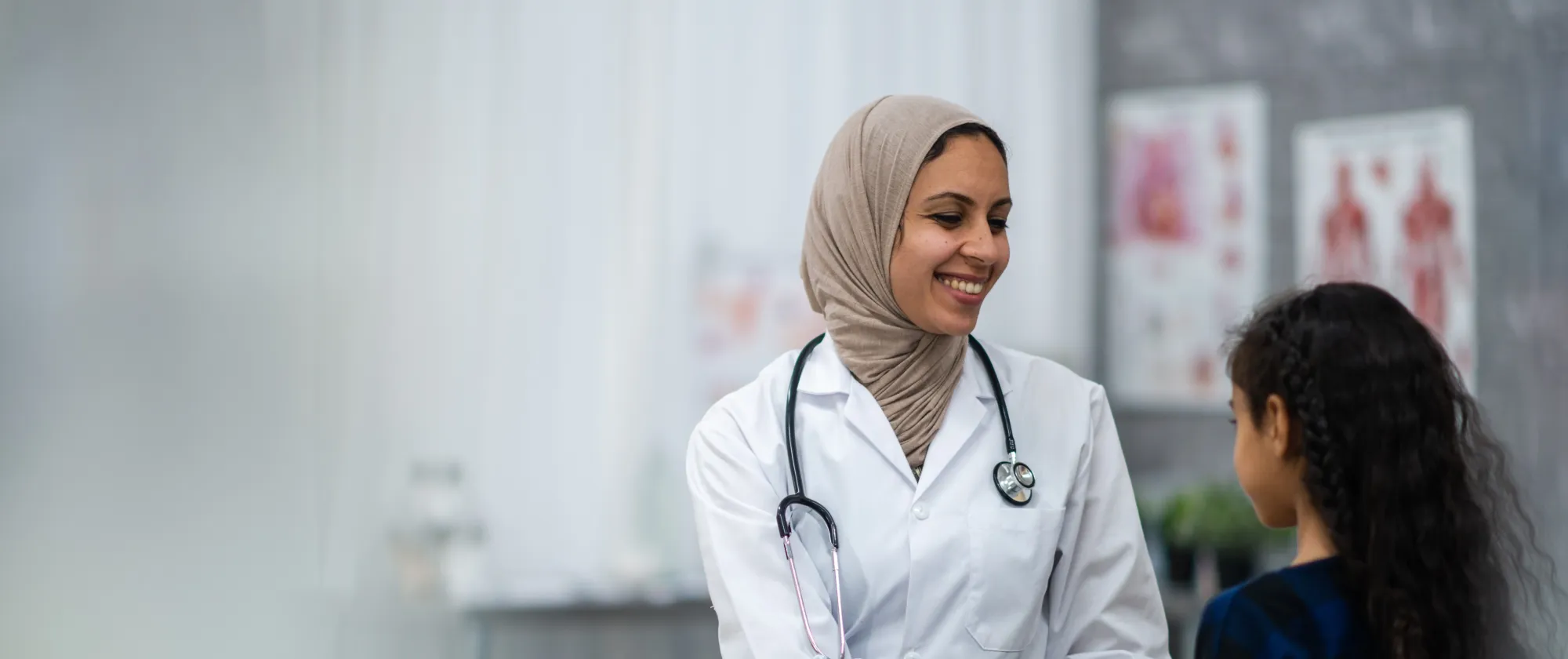 A female doctor reassuring a young girl in her clinic in Canada.February 14, 2022