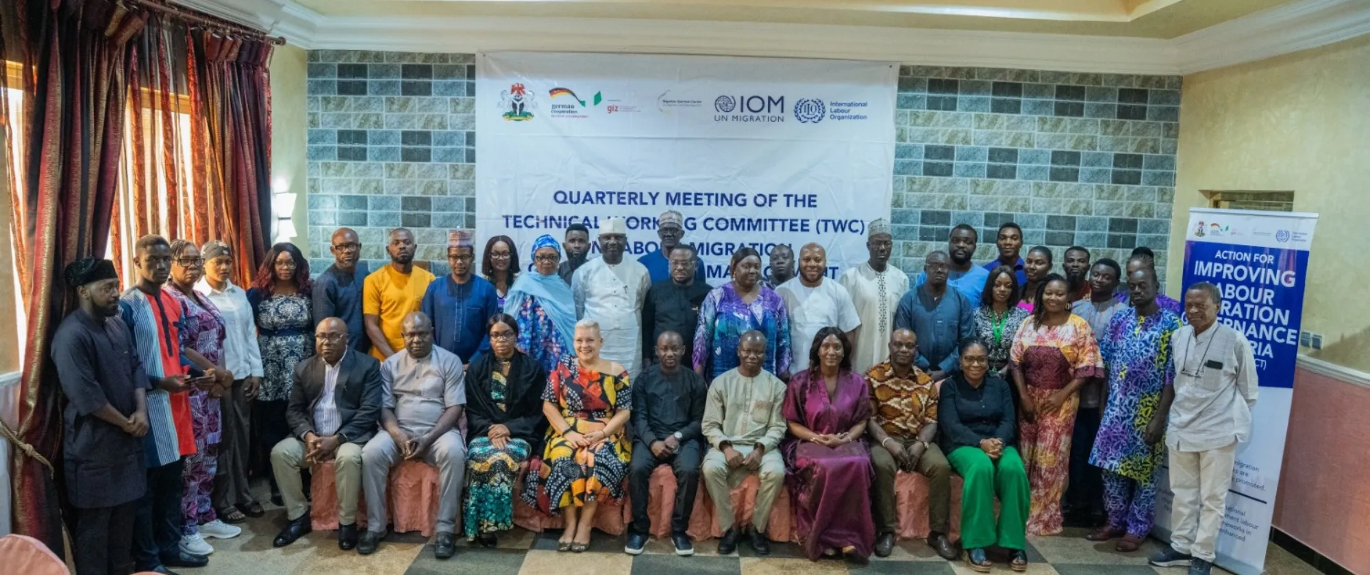 A large group of participants from government agencies, labour organizations, and development partners posing for a group photo during the Technical Working Committee meeting in Abuja