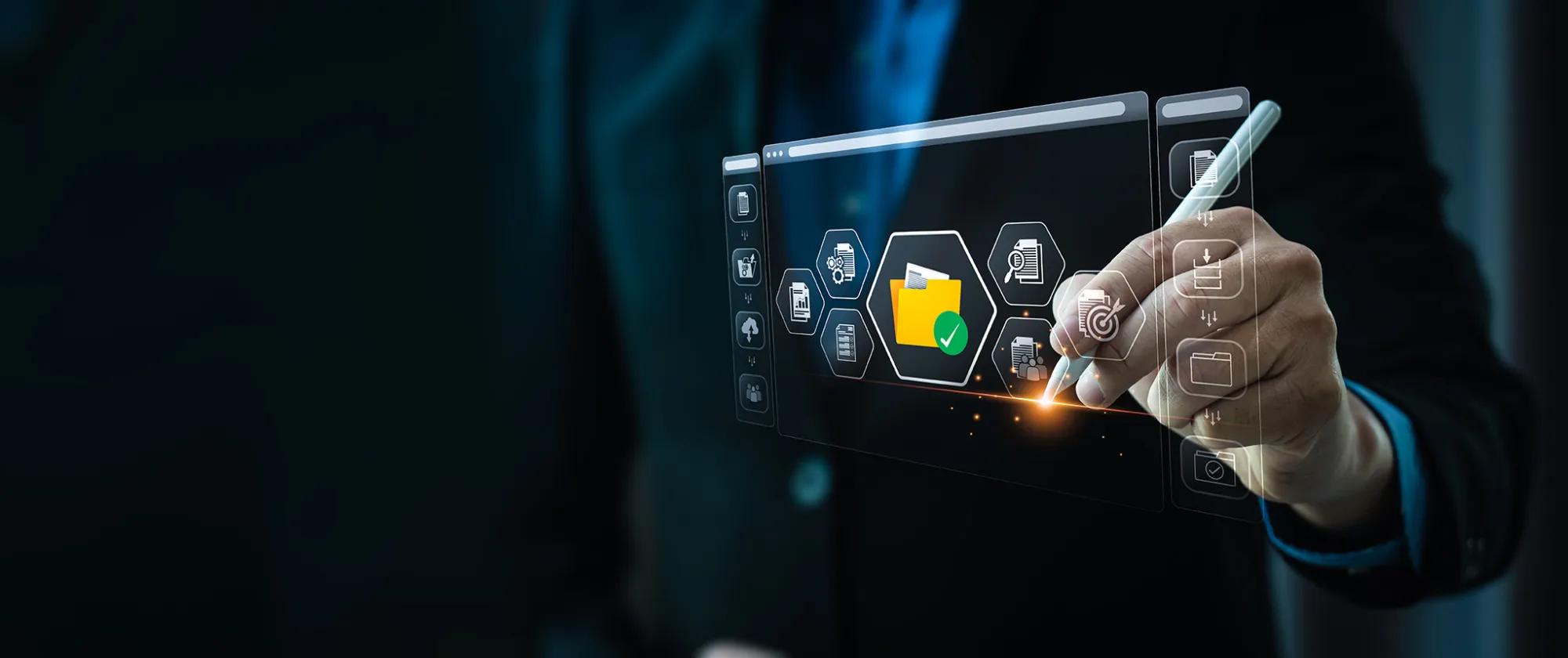 A professional hand in a blue suit sleeve holds a stylus pen, interacting with a futuristic holographic display featuring file folder icons, including a prominent glowing yellow folder with a green checkmark, against a dark background.
