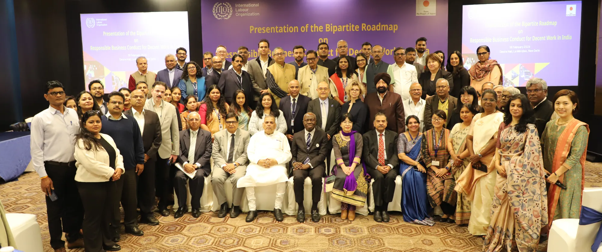 Group photo in a hotel meeting room