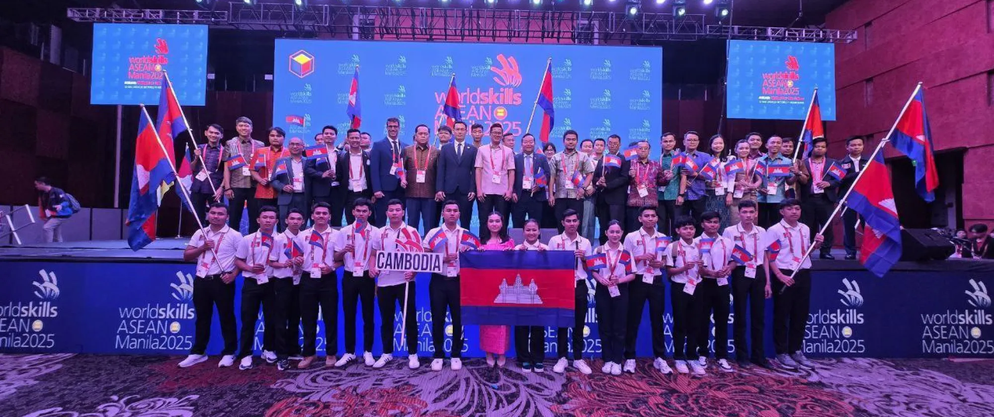 Group photo of all competitors representing Cambodia on stage.