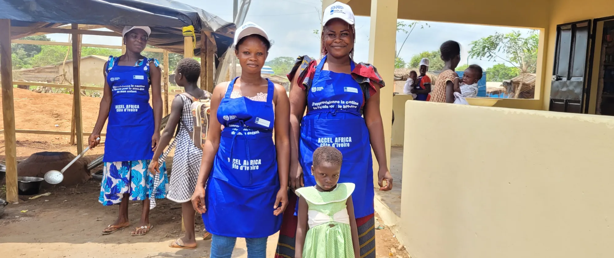 Women beneficiaries of ACCEL Africa interventions wearing a blue apron 