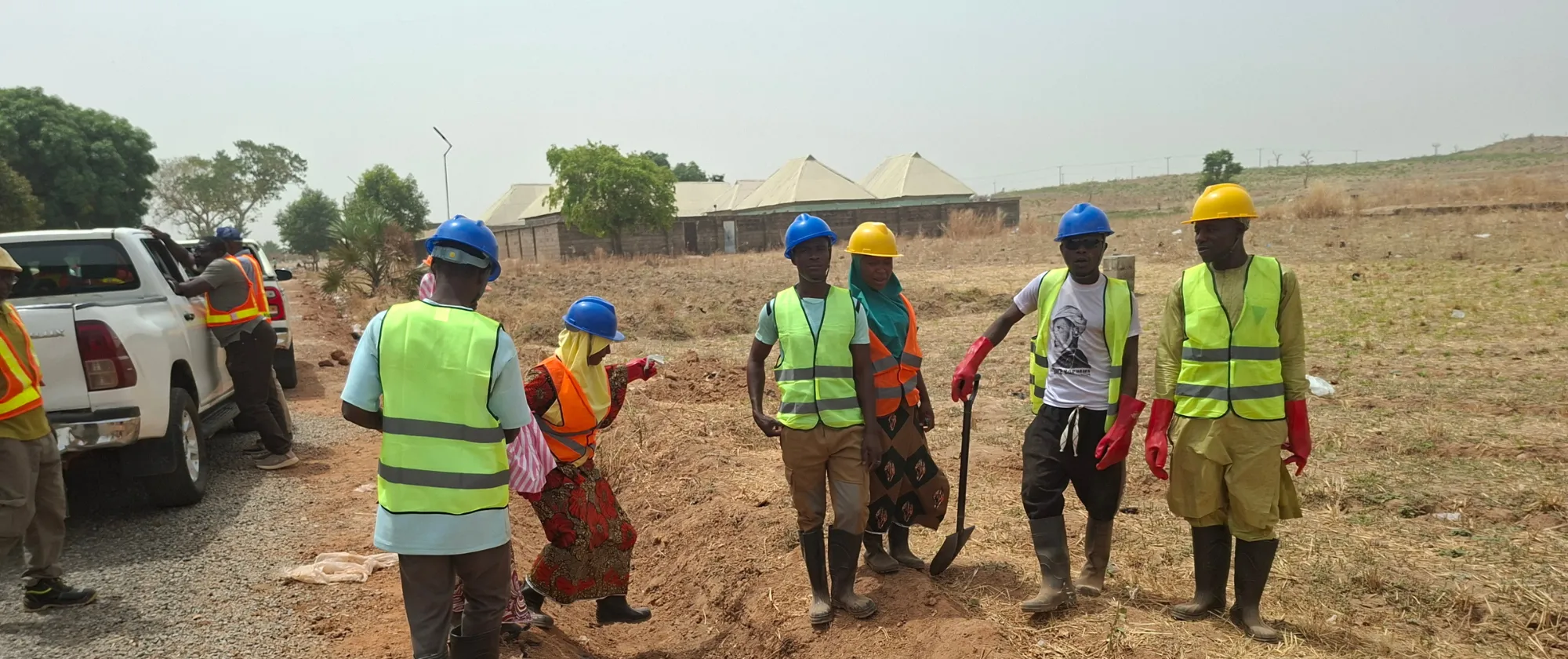 Men and women gathered along a rural road in Niger State take part in practical training on road maintenance techniques as part of RAAMP.